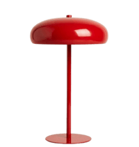 a red table lamp on a black background